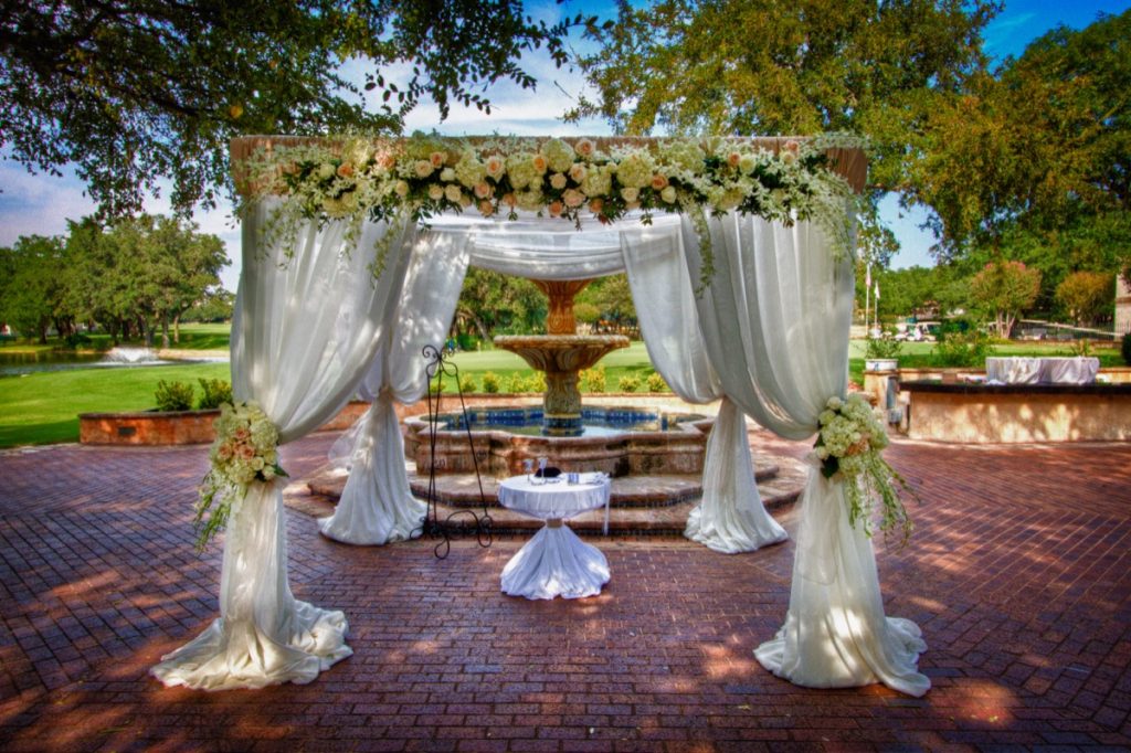 Even an already elegant place gets even more elegant by Events by A Touch of Elegance! This Canopy of flowers and drapery adds a charm and romance to pristine patio!