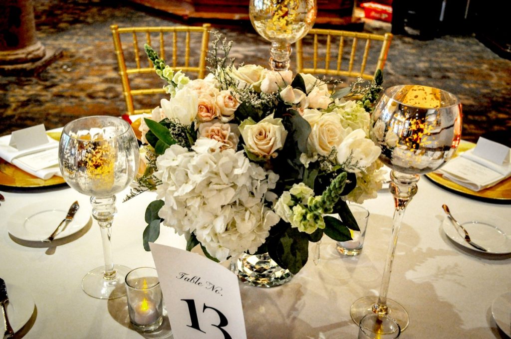 The centerpiece at table no. 13 is all gold, and white, and green. Elegance is found at The Dominion.