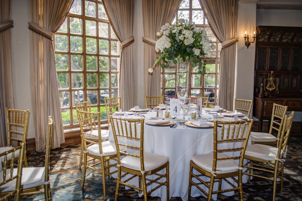 The outdoor light enhances the romantic nature of this room at Golden chairs and white tablecloths make this ballroom at The Dominion!