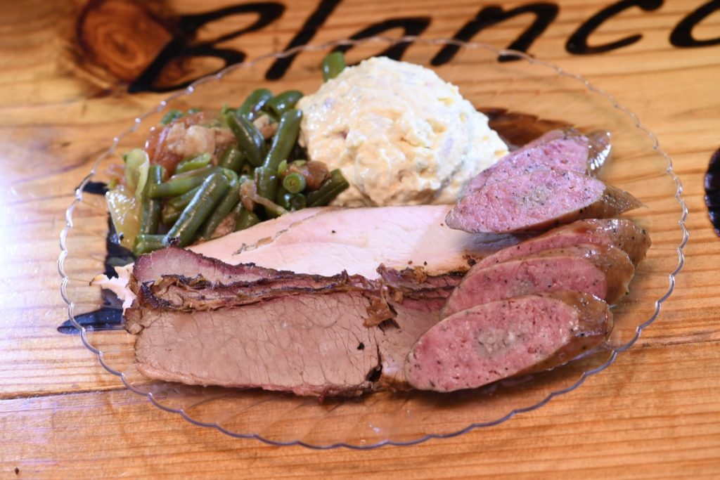 Blanco BBQ serves a three course meak of BBQ, Pork sausages, turkey with a smattering of green beans and a dollop of mashed potatoes. Yum!