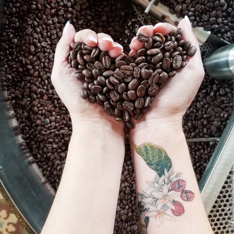 Coffeecionado-hand holding beans in a heart shape