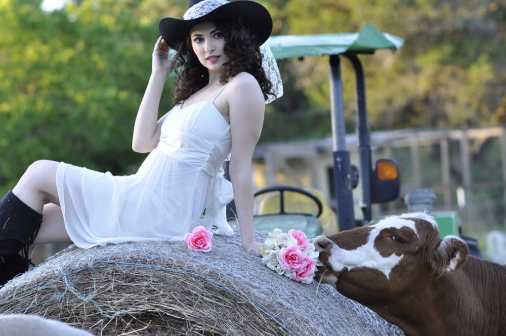A country beauty on a haystack. Watch out for that cow! Indulgences Hair & Body Salon