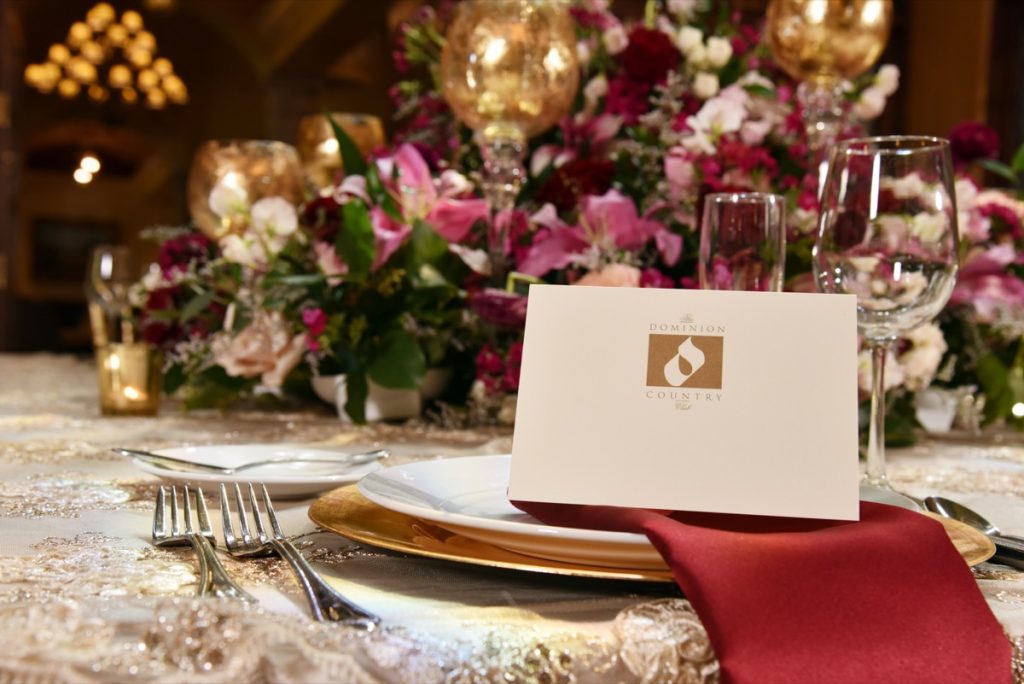 A centerpiece with a The Dominion Country Club placard.