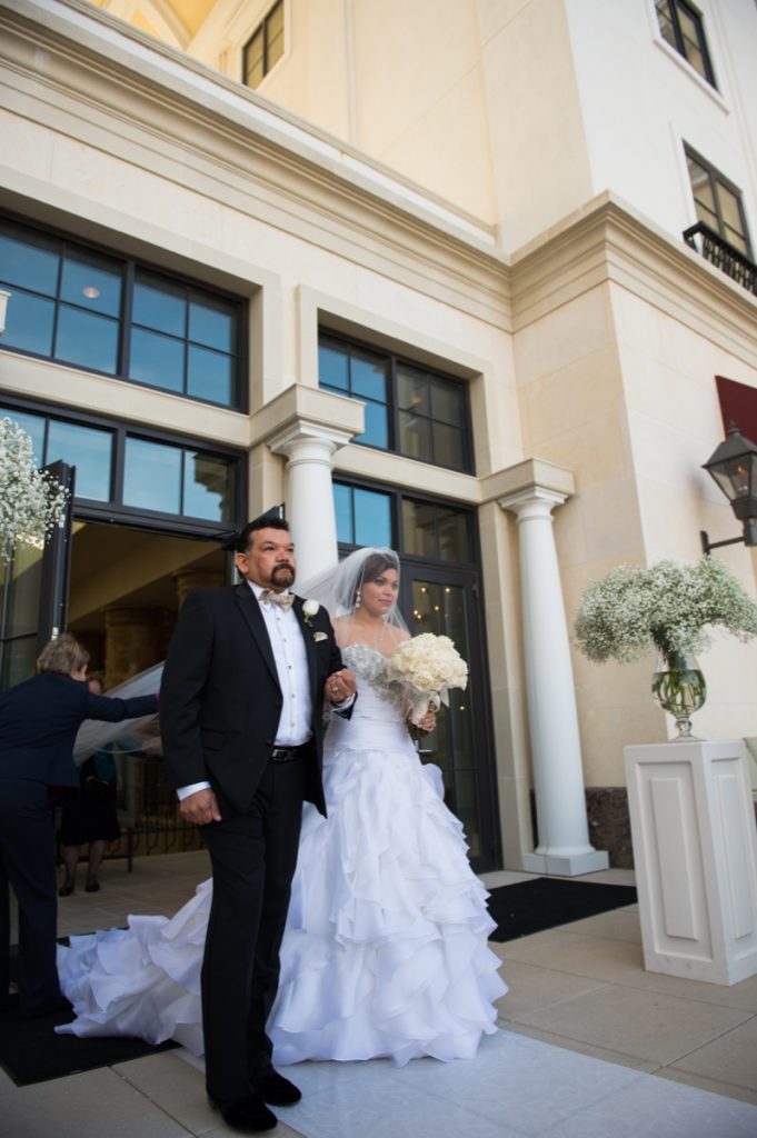 A bride and her tense father awaiting the moment to walk down the aisle at The Eilan Hotel Resort and Spa