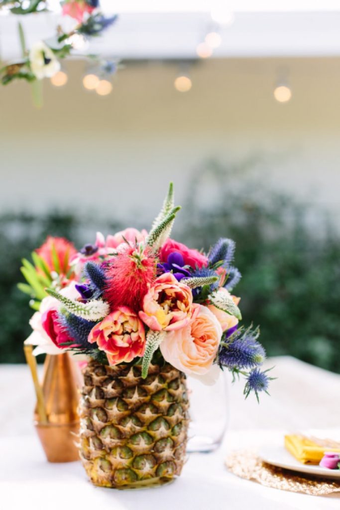 Hey! It's a coconut vase being used as a vase for a bouquet! What a marvelous idea from Freesia Designs!