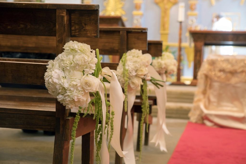 White flowers adorne the Emporium by Yarlen's pews set-up for a wedding.
