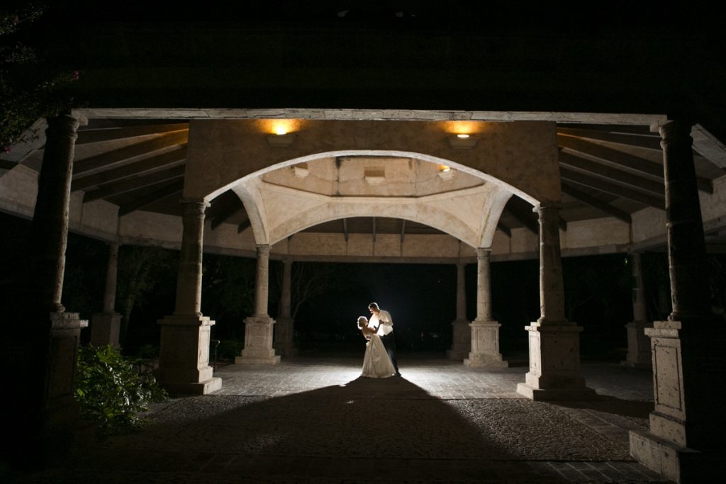 A couple dancing by themselves under the gondela-like structure at The Dominion Country Club.