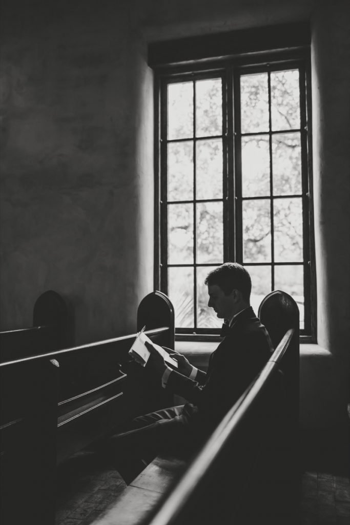 A sna sits at a pew at Lost Mission reading