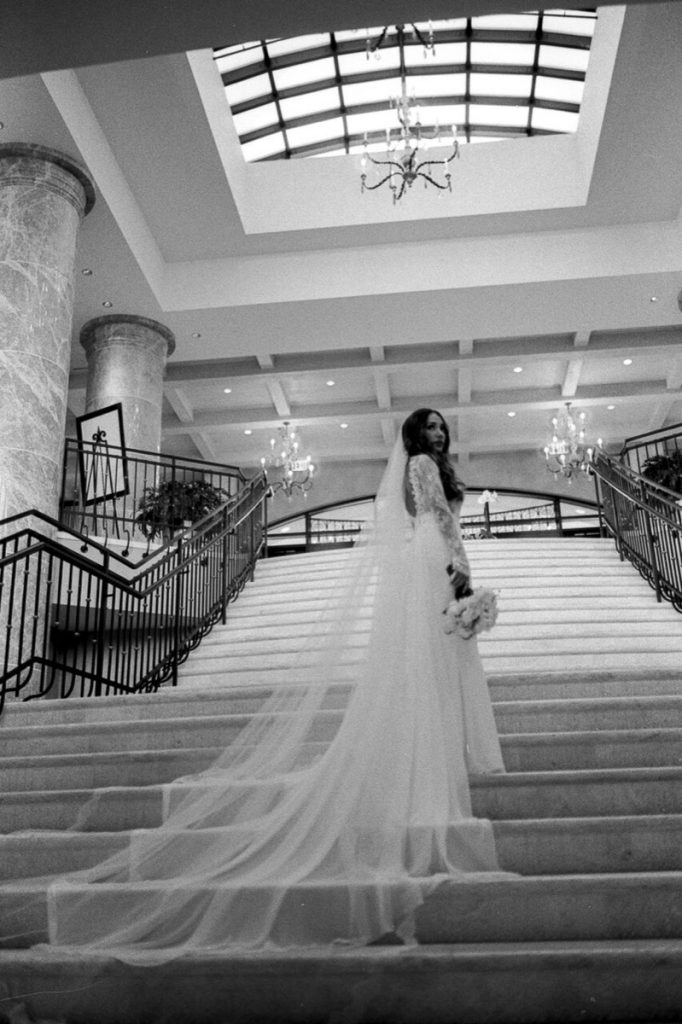 The Eilan Hotel Resort and Spa has wonderful staircases such as shown here in beautiful black and white photograph of a bride on her way up!