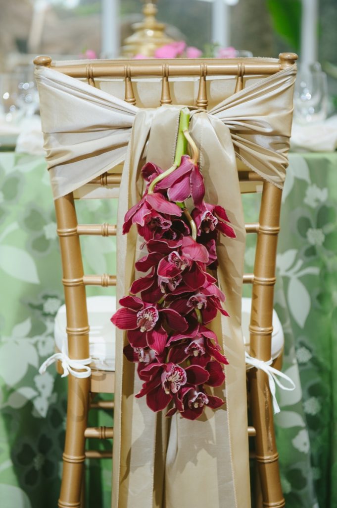 A close-up of the back of the wedding chair as decorated by Illusions Tents, Rentals, and Designs