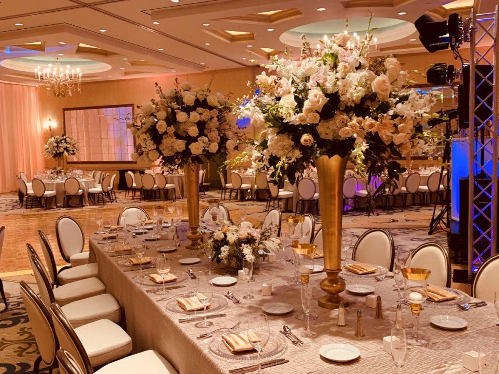 White roses rule the tables as they are the centerpieces in this banquet, curtesy of Events by A Touch of Elegance!