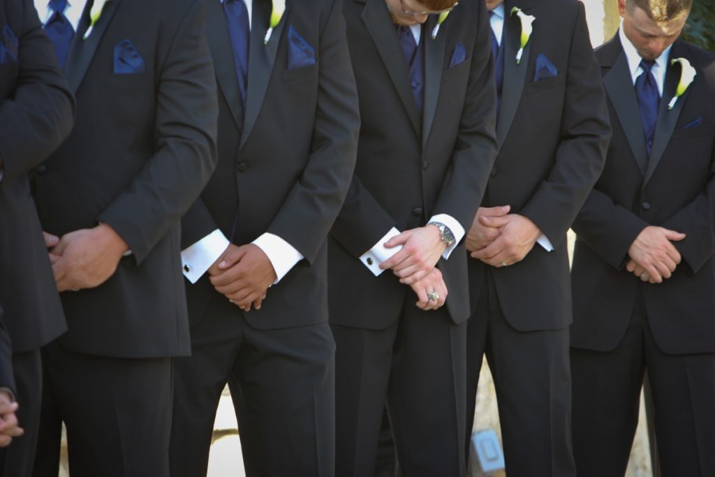 Six men in prayer during a ceremony at La Cantera Resort and Spa