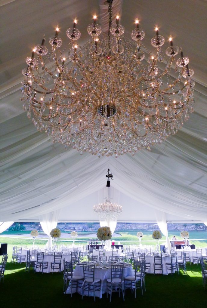 A grand chandelier hangs in an outdoor tent erected for the banquet at La Cantera Resort and Spa.