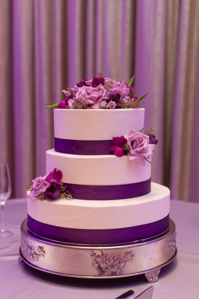 Cake! A grand tradition anytime! This is a purple and white, probably very delicious, three tiered cake!