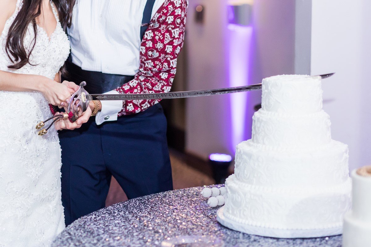 cutting wedding cake with Texas ATm sword