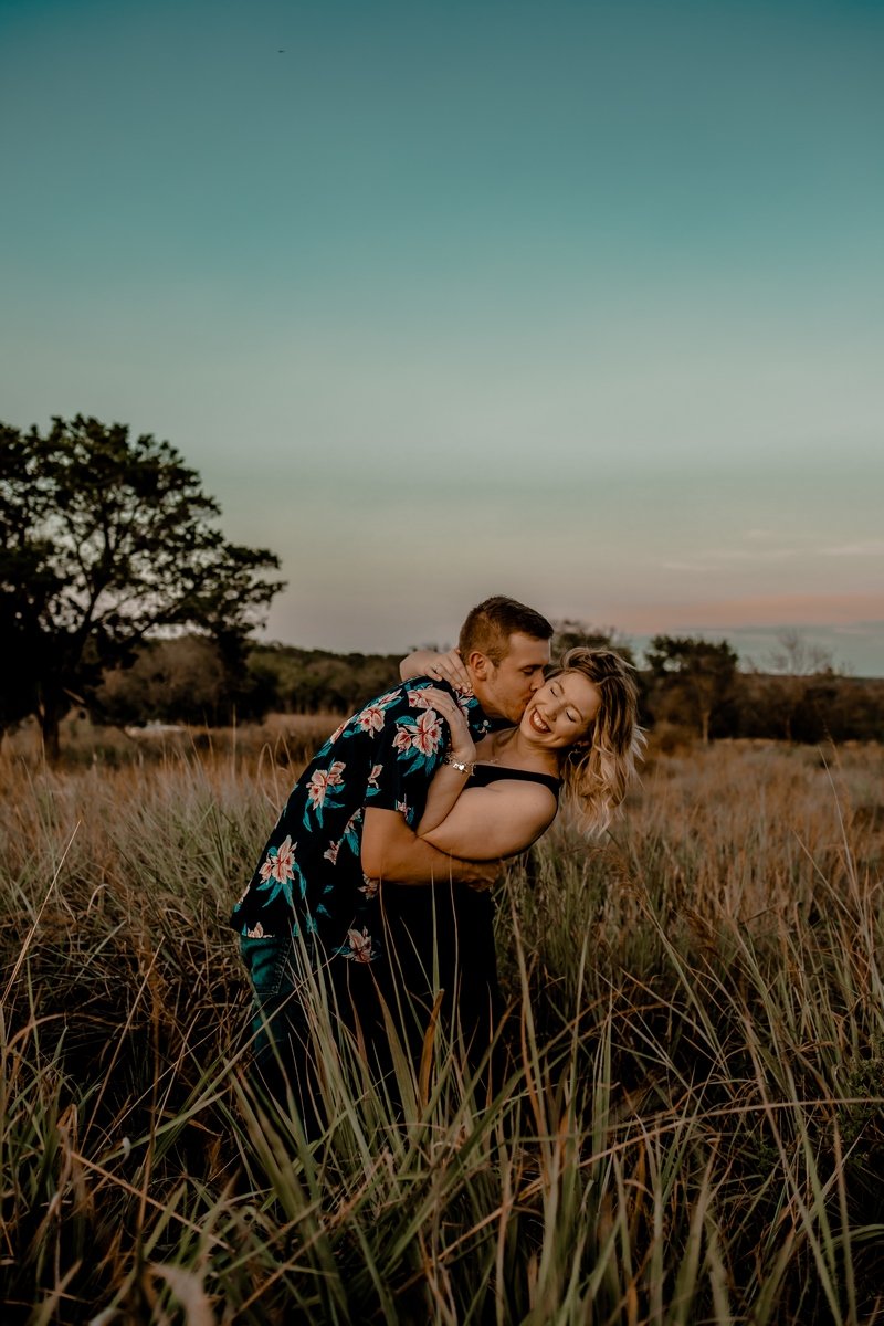 Man and woman embracing in field