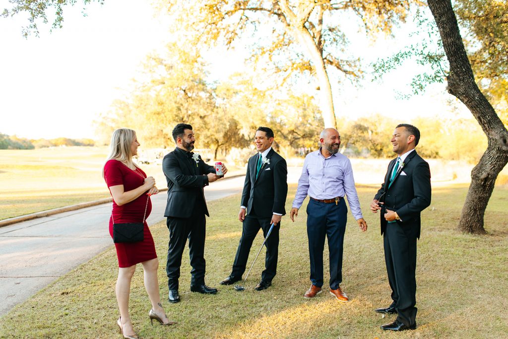 wedding guests talking to the groom at golf course