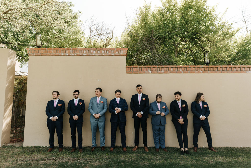 groomsmen in alternating shades of blue texas wine country